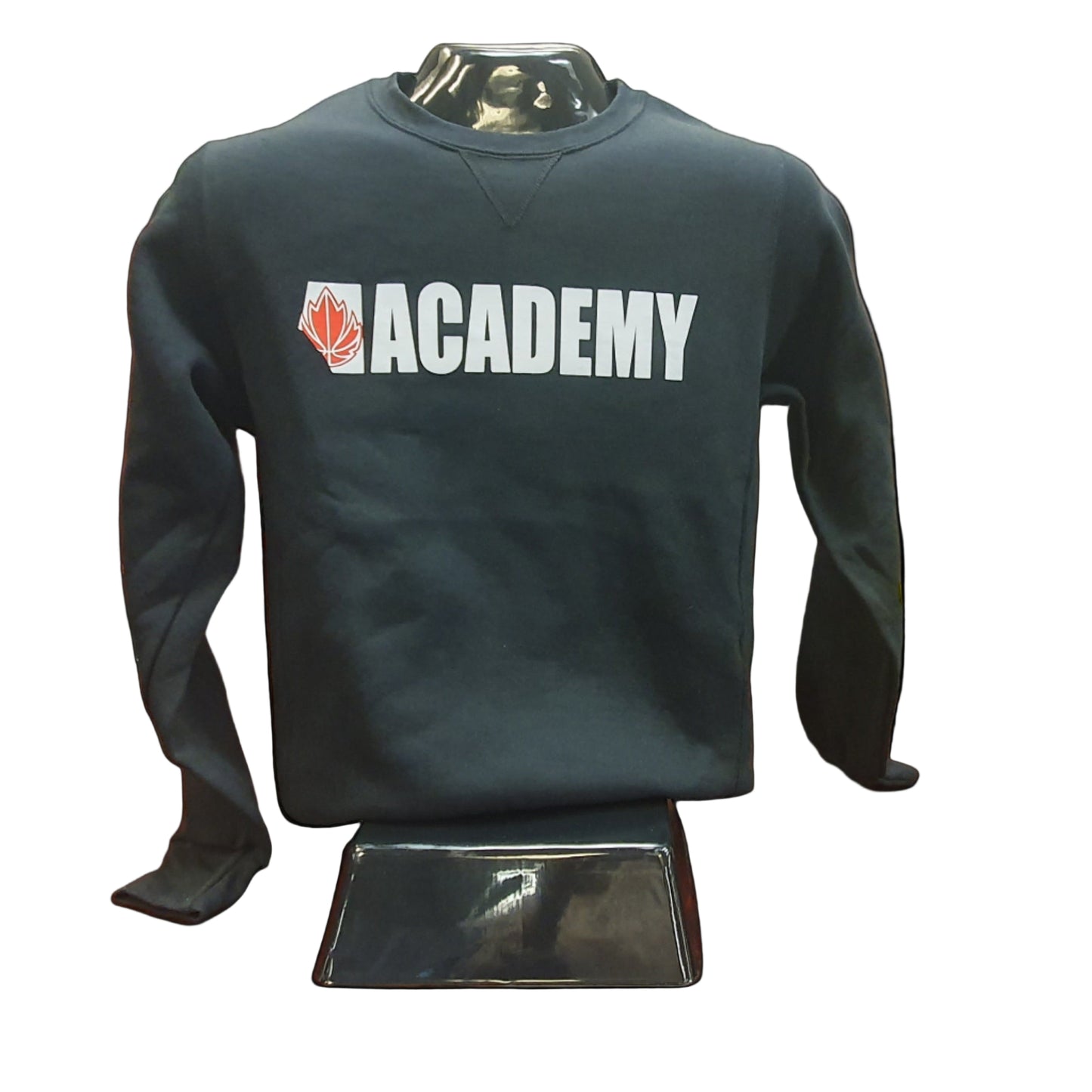Black sweatshirt with 'Academy' logo on a mannequin in a storage room.