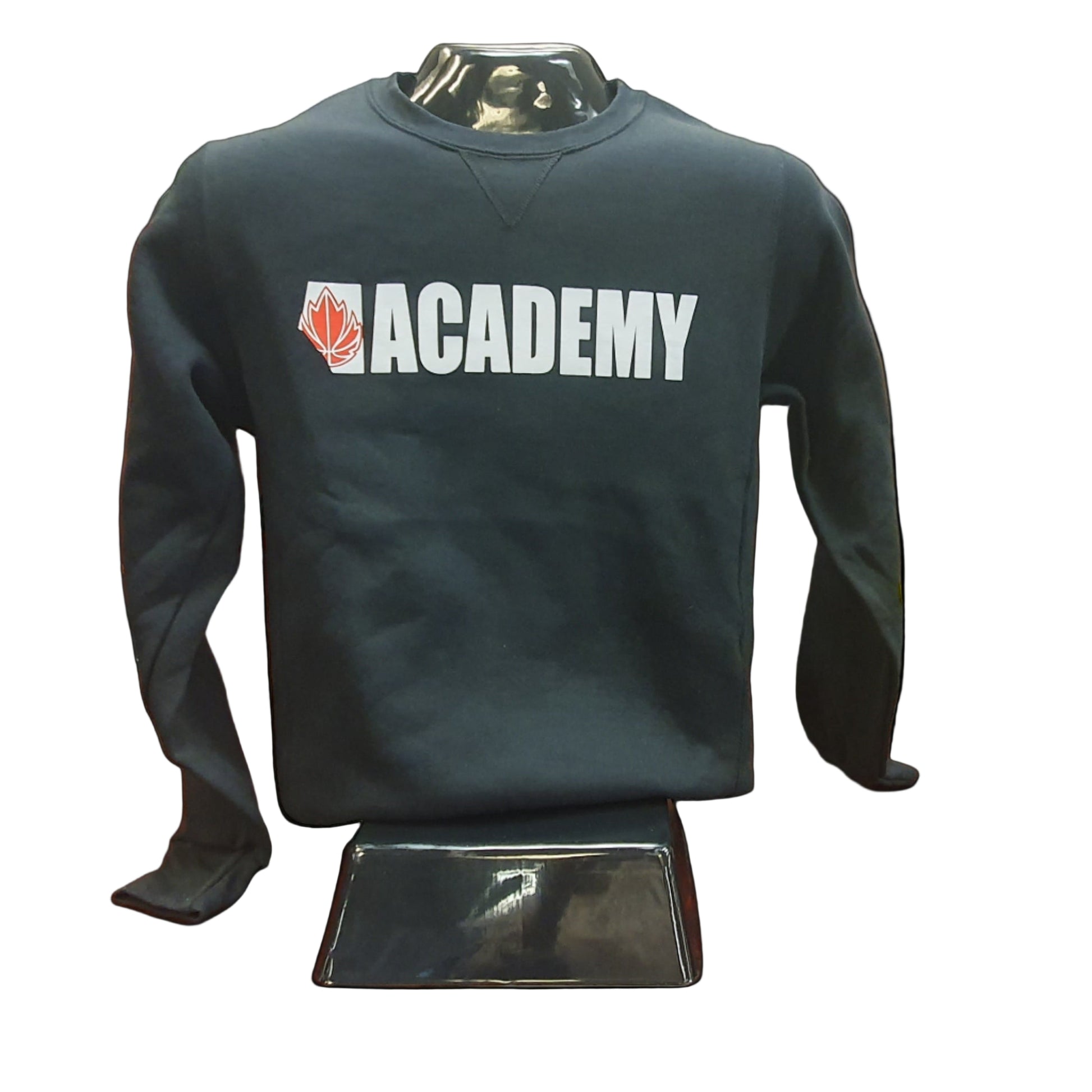 Black sweatshirt with 'Academy' logo on a mannequin in a storage room.